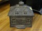 (OFC) CAST IRON COIN BANK; BLACK CAST IRON HOSE SHAPED COIN BANK WITH COIN SLOT ON TOP. MEASURES 5.5