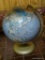 (DNRM) WORLD GLOBE; SPINNING GLOBE ON A METAL AXIS AND STAND. MEASURES 16 IN TALL.