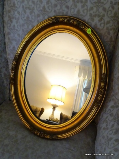 (LR) OVAL WALL MIRROR; OVAL WALL MIRROR WITH A BRONZE FINISHED WOODEN FRAME WITH FLORAL AND RIBBON