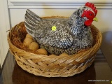 (DR) CHICKEN IN A BASKET; LARGE PORCELAIN CHICKEN WITH 8 EGGS IN A NESTED WOVEN BASKET. MEASURES 16