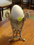 (DR) LARGE MARBLE EGG WITH STAND; LARGE WHITE MARBLE EGG SITTING IN AN EGG CUP STYLE STAND WITH