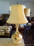 (LR) CERAMIC VASE SHAPED TABLE LAMP; WHITE VASE SHAPED TABLE LAMP WITH PINK ROSES AROUND THE SIDES.