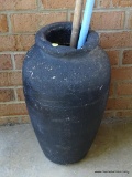 (OUT) LARGE BLACK JAR; LARGE BLACK JAR TO INCLUDE A WOODEN BROOM AND A PLASTIC BROOM. JUG MEASURES