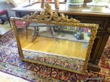 (LR) LARGE MIRROR; HAND CARVED FRAME WITH FLORAL DESIGNS AROUND THE TOP AND SHOULDERS AND AN
