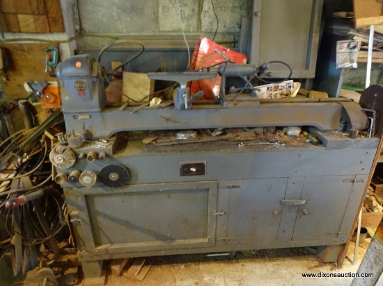 VINTAGE DELTA MILWAUKEE LATHE; DELTA LATHE THAT SITS ON A CUSTOM MADE BENCH WITH LOWER CABINETS.