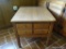 (DEN) WOODEN END TABLE; WOOD GRAIN END TABLE WITH A 4 PANELED DOVETAIL DRAWER WITH 4 METAL KNOBS.