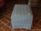 (DEN) FOOT STOOL; BLUE AZTEC PATTERNED CLOTH FOOTSTOOL WITH AN A SKIRT AND 4 BLOCK FEET. MEASURES 1