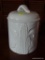 (DEN) OVER AND BACK INDOOR OUTFITTERS CANISTER; WHITE CANISTER WITH A LID THAT HAS A FAN DETAILED