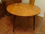 (KIT) DROP LEAF DINING TABLE; ROUND WOODEN DINING TABLE WITH SINGLE LEAF. SITS ON 4 TURNED LEGS.