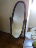 (UPMR) CHEVAL MIRROR; OVAL WOOD FRAMED MIRROR ON TURNED POSTS WITH CURVED LEGS. MEASURES 2 FT 2 IN X