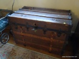 (UPMR) STEAMER TRUNK; WOODEN TRUNK WITH METAL SIDE AND CORNER REINFORCEMENTS, 3 FRONT LATCHES.