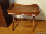 (UPSIT) BUTLER TRAY END TABLE; WOODEN BUTLER TRAY TOP WITH SIDE HANDLES SITTING ON A CREAM AND BROWN