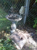 (OUT) CONCRETE BIRD BATH; PINEAPPLE CARVED BASE WITH ROUND BOWL AND A CHERUB ANGEL SITTING ON THE
