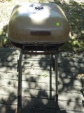 (OUT) MECO CHARCOAL GRILL; TAN AND BLACK MECO SWINGER II. MODEL 4400. LOWER INSIDE PAN HAS SOME