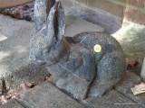(OUT) RABBIT STATUE; FADED BLACK SOLID CEMENT RABBIT STATUE. MEASURES 13 IN X 6 IN X 11.5 IN.