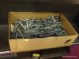 BOX FULL OR ROUND TOP CARRIAGE BOLTS; CARDBOARD BOX FULL OF 4.5 IN CARRIAGE BOLTS.