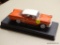 CHEVY MODEL CAR; VINTAGE CHEVY IMPALA MODEL CAR WITH AN ORANGE COLOR AROUND THE CAR AND A WHITE