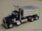 TOY DUMP TRUCK; KENWORTH TOY DUMP TRUCK WITH A CHROME TRAILER, A BLACK CAB, AND A DUMPING TRUCK BED