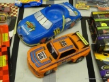 LOT OF PLASTIC RACING CARS; 2 PIECE LOT TO INCLUDE A FLOATING KOOZIE AND A BROKEN REMOTE CONTROL