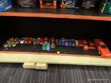 SHELF LOT OF TOY CARS; SOME ARE GO KARTS, SOME ARE NASCAR THEMED, AND SOME ARE DIECAST.