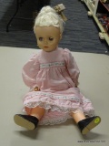 COLLECTIBLE DOLL; STAMPED HORSMAN T21 ON THE BACK OF THE NECK. DOLL HAS BLONDE HAIR WITH A PINK AND