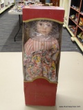 COLLECTIBLE PORCELAIN DOLL; DOLL IS DRESSED IN A STRIPED AND FLORAL SUMMER STYLE DRESS WITH BROWN