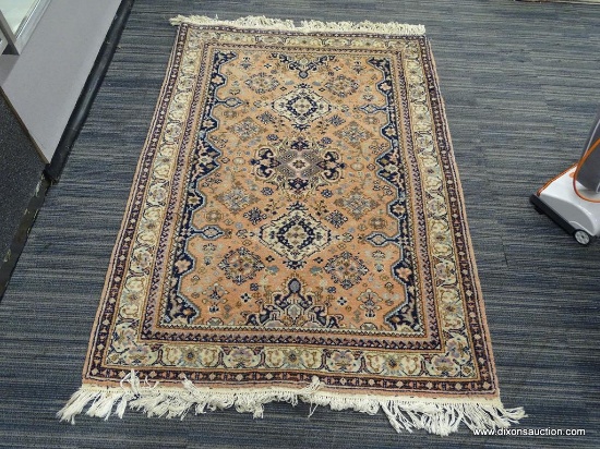 HAND KNOTTED RUG; PINK AND CREAM HAND KNOTTED RUG WITH BLUE, CREAM, AND ROSE PATTERN. HAS FRINGE