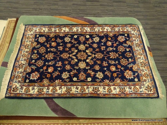 HAND KNOTTED KASHAN RUG; NAVY BLUE, AND CREAM COLOR KASHAN RUG WITH RED, BLUE AND GREEN FLOWERS. HAS