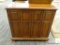 WOODEN CABINET; MAHOGANY CABINET WITH 2 BI-FOLD OPENING DOORS WITH METAL KNOBS THAT OPENS TO REVEAL