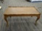 (R2) WOODEN COFFEE TABLE; WOOD GRAIN COFFEE TABLE WITH A BRACKET DETAILED LIP AROUND THE TABLE TOP,