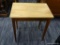 (R2) WOODEN SIDE TABLE; RECTANGULAR LIGHT COLORED WOODEN TOP SITTING ON 4 TAPERED MAHOGANY LEGS. TOP