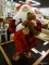 (R3) LARGE SANTA FIGURINE; SANTA IN HIS RED PLAID PAJAMAS AND REINDEER SLIPPERS HOLDING A BEAR AND A