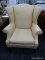 (R4) WINGBACK SIDE CHAIR; PALE YELLOW UPHOLSTERED WINGBACK CHAIR WITH REMOVABLE SEAT CUSHION.