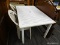 (R4) METAL TABLE; WHITE METAL PATIO TABLE WITH A PANELED TABLE TOP. SITS ON 4 BLOCK LEGS. MEASURES 5