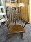 (R4) ROCKING CHAIR; WOODEN ROCKING ARMCHAIR WITH A BANNISTER BACK. HAS A ROUNDED FRONT AND TAPERED