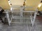 (R5) GLASS TV STAND; GLASS PANELED GRAY METAL TV STAND WITH 3 GLASS SHELVES. MEASURES 3 FT 5.5 IN X