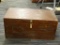 CHERRY CHEST; WOODEN CHEST WITH A PAD LOCK LATCH ON THE FRONT. MEASURES 2 FT 8 IN X 1 FT 4.75 IN X 1