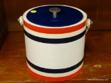 (R1) ICE BUCKET; PLASTIC ICE BUCKET WITH LID AND ROPE HANDLE. HAS A PLASTIC WRAPPING ALONG THE