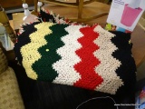 (R2) YARN BLANKET; HANDMADE YARN BLANKET WITH TASSELS ON THE SIDES.