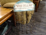 (R2) DECORATIVE WINE RACK; METAL WINE RACK WITH A FAUX WOOD BACK DROP AT THE TOP THAT SAYS 