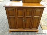 WOODEN CABINET; MAHOGANY CABINET WITH 2 BI-FOLD OPENING DOORS WITH METAL KNOBS THAT OPENS TO REVEAL