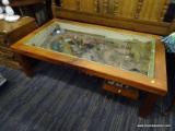 (R2) MODEL TRAIN COFFEE TABLE; WOODEN COFFEE TABLE WITH A MODEL TRAIN TRACK CITY ON THE INSIDE. HAS