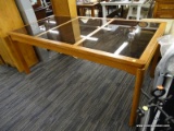 (R3) GLASS PANEL TABLE; WOODEN TABLE WITH 3 TINTED GLASS PANELS. THERE'S A CHIP ON THE CORNER OF ONE