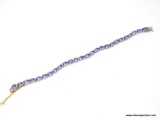 TANZANITE AND DIAMOND 7 INCH BRACELET; 14KT WHITE GOLD SETTING WITH 26 OVAL MIXED CUT NATURAL