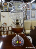 (R4) GLASS OIL LAMP; OIL LAMP WITH A ROUNDED BASE AND A DEEP ORANGE OIL TANK. COMES WITH A BELL