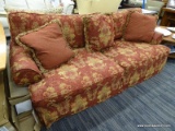 (R4) ROLL ARM SOFA; 2 CUSHIONED ROLL ARM SOFA WITH A RED FABRIC WITH YELLOWISH GREEN FLORAL PATTERN.