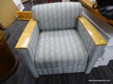 (R4) ARM CHAIR; BLUE FABRIC ARM CHAIR WITH WOODEN PLANK ARM RESTS. FABRIC HAS FLORAL DETAILING.