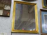 (R6) FRAMED WALL MIRROR; RECTANGULAR MIRROR FRAMED IN A GOLD GILT FRAME. MEASURES 21.5 IN X 27.5 IN.