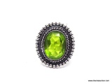 (SHOW) LADIES GERMAN SILVER RING; OVAL SHAPED GREEN PERIDOT AND GERMAN SILVER RING. SIZE 8.