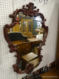 (R1) ORNATE WALL MIRROR; DEEP RED SCROLLING WALL MIRROR WITH INTRICATELY CARVED DETAILS. MEASURES 2